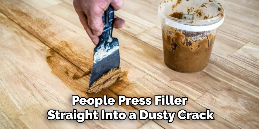 People Press Filler 
Straight Into a Dusty Crack